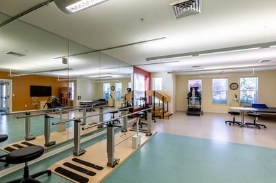Rehabilitation gym with exercise equipment and therapy bars