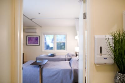 A view into a private resident room with beds