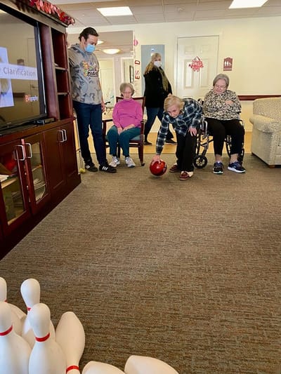 The Inn at Fairview, nursing home in Hudson, NH — Residents participating in a bowling activity indoors