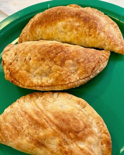 The Inn at Fairview, nursing home in Hudson, NH — Golden-brown baked empanadas on a green plate