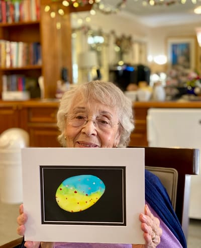 The Inn at Fairview, nursing home in Hudson, NH — Elderly woman displaying colorful painted rock artwork
