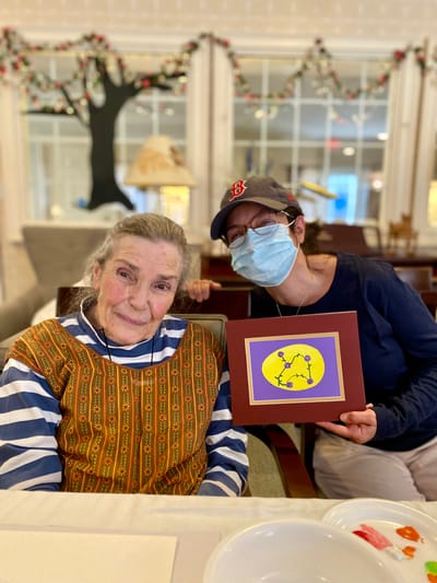 The Inn at Fairview, nursing home in Hudson, NH — Two women posing with an art project in a dining area