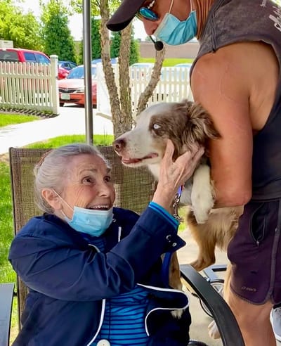 The Inn at Fairview, nursing home in Hudson, NH — Senior resident joyfully interacting with a dog