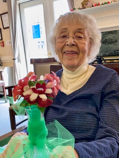 The Inn at Fairview, nursing home in Hudson, NH — Senior woman holding a handmade flower bouquet
