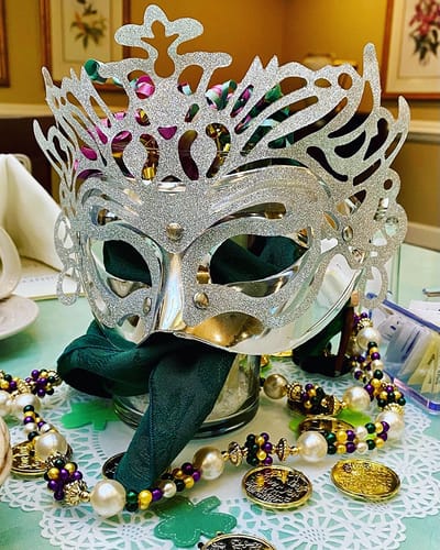 The Inn at Fairview, nursing home in Hudson, NH — Decorative Mardi Gras mask with beads and green napkins