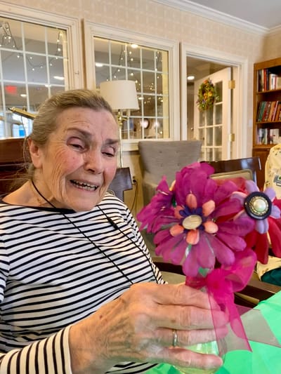 The Inn at Fairview, nursing home in Hudson, NH — Senior resident creating floral craft with bright materials