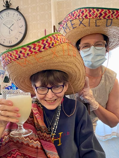 The Inn at Fairview, nursing home in Hudson, NH — Two women wearing sombreros celebrating with drinks