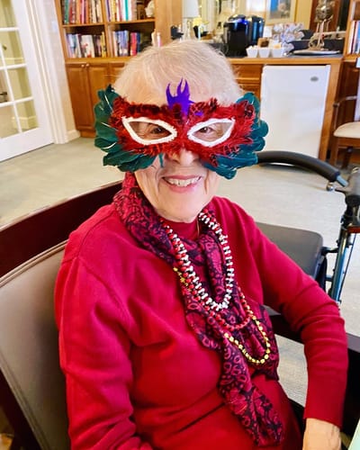 The Inn at Fairview, nursing home in Hudson, NH — Senior woman wearing a decorative masquerade mask and beads