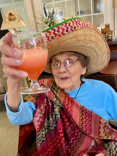 The Inn at Fairview, nursing home in Hudson, NH — Senior resident celebrating with a drink and sombrero