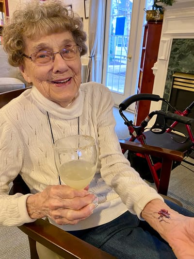 The Inn at Fairview, nursing home in Hudson, NH — Elderly woman enjoying a drink in a cozy living room