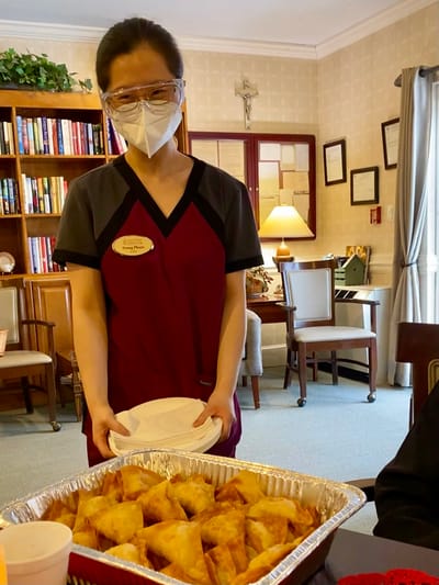 The Inn at Fairview, nursing home in Hudson, NH — Staff member serving snacks in a communal living area