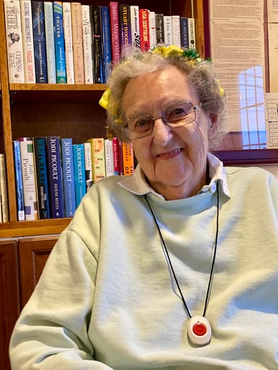 The Inn at Fairview, nursing home in Hudson, NH — Smiling senior resident wearing a medical alert pendant