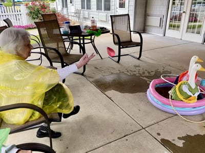 The Inn at Fairview, nursing home in Hudson, NH — Senior resident interacting with playful inflatable ducks