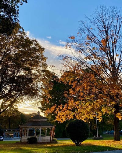 The Inn at Fairview, nursing home in Hudson, NH — Gazebo surrounded by autumn trees at sunset