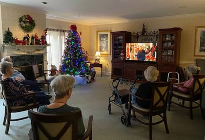 The Inn at Fairview, nursing home in Hudson, NH — Residents enjoying a holiday movie by a decorated Christmas tree