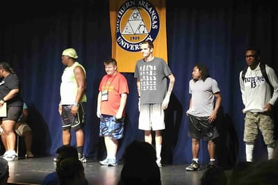 Pathfinder, Inc. Longwood ICF/IID, assisted living in Searcy, AR — Participants lined up on stage for an event