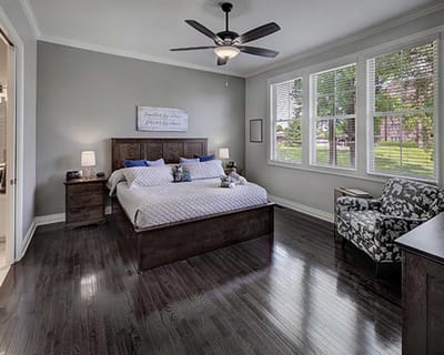 Bright interior of a resident room with bed and seating