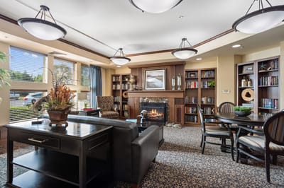 Cozy common area with fireplace and bookshelves