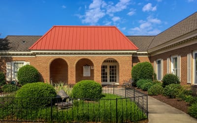 Building exterior with landscaping and red roof