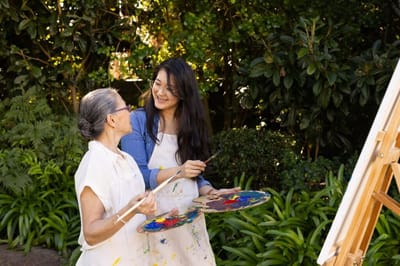 Residents enjoying a painting activity in a garden