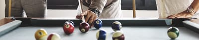 Residents playing billiards in an activity room