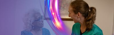 Staff member engaging with a resident in a friendly conversation