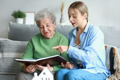Resident and caregiver engaging with a photo book