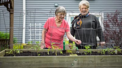Two residents tending to a garden