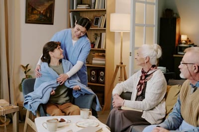 Staff member assisting a resident in a cozy common area