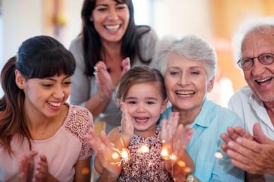 Residents and staff celebrating with a child