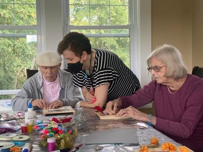 Residents and staff engaged in a craft activity