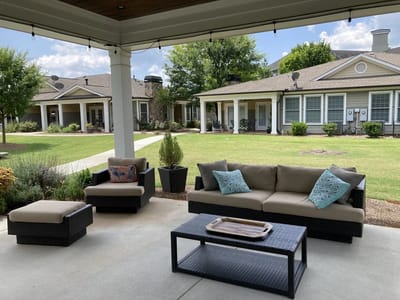Outdoor seating area with comfortable couches and garden views