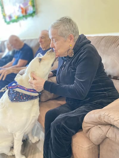 Resident interacting affectionately with a dog