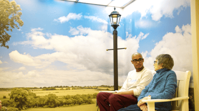 A caregiver conversing with a resident in a cozy setting