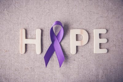 Purple ribbon with letter blocks spelling 'HOPE'