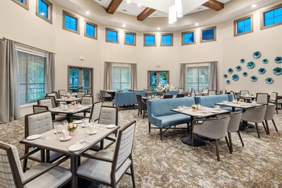 Bright dining room with tables set for meals