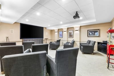 Interior view of a common area with seating and a large screen