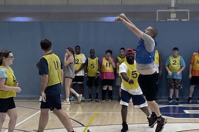 Residents participating in a basketball activity