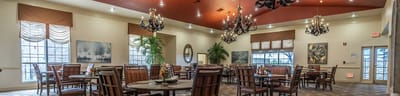 Bright dining area with elegant furnishings and chandeliers