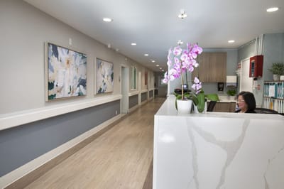 Reception area with floral decor and paintings