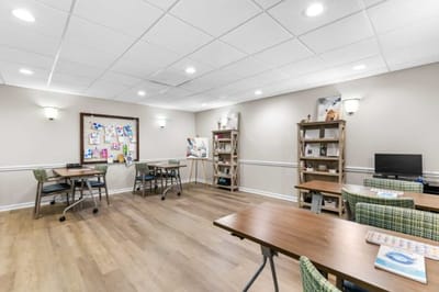 Bright activity room with tables and art displays