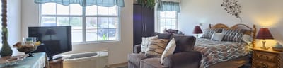 Cozy resident room with bed and seating area