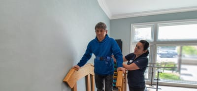 Residents receiving assistance while using stairs