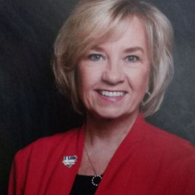 Pathfinder, Inc. Longwood ICF/IID, assisted living in Searcy, AR — Professional portrait of a smiling woman in a red jacket