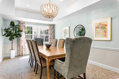 Bright common area with dining table and windows