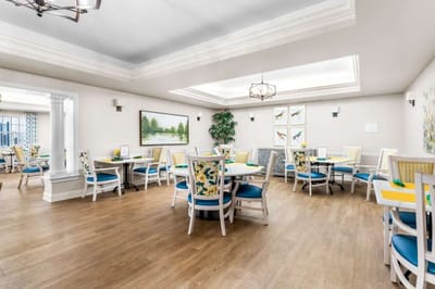 Bright common area with dining tables and chairs