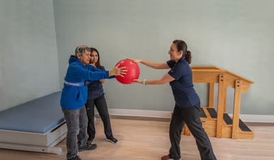 Residents participating in a therapy activity with staff