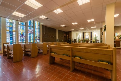 Interior view of a chapel with wooden pews