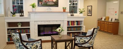 Cozy lounge area with bookshelves and fireplace