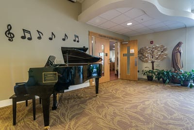 Interior view of a lobby with a piano and decorations